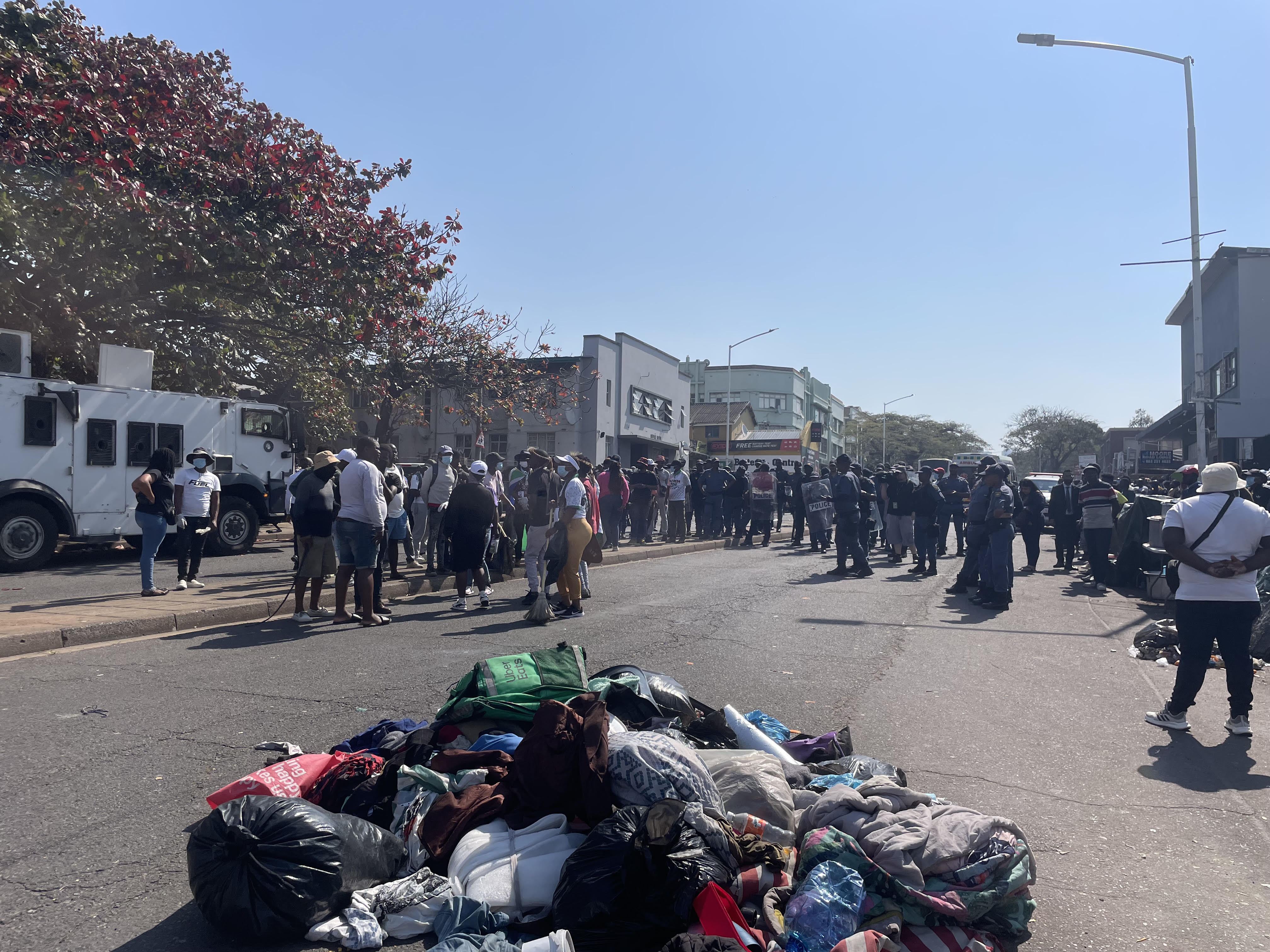 Belongings and bedding piled along Che Guevara Road during confrontations outside the Durban refugee office.