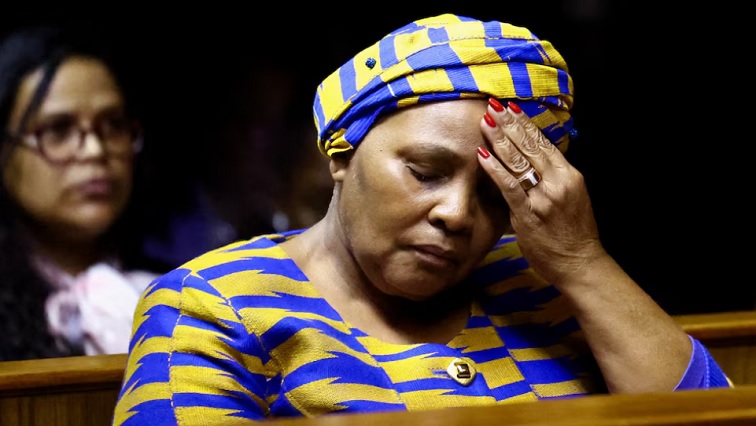 Nosiviwe Mapisa-Nqakula listening to proceedings from the dock where she faces 12 counts of corruption and one count of money laundering.